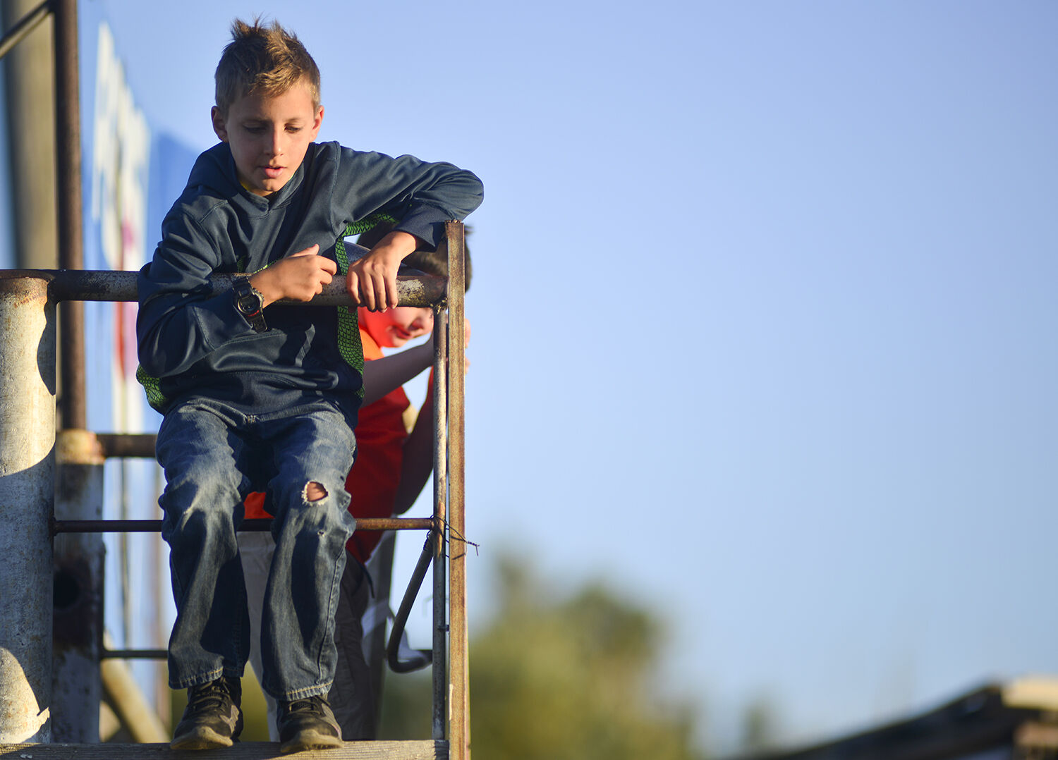 Vance Thorson, 12, looks down over the shoots from an overhead platform